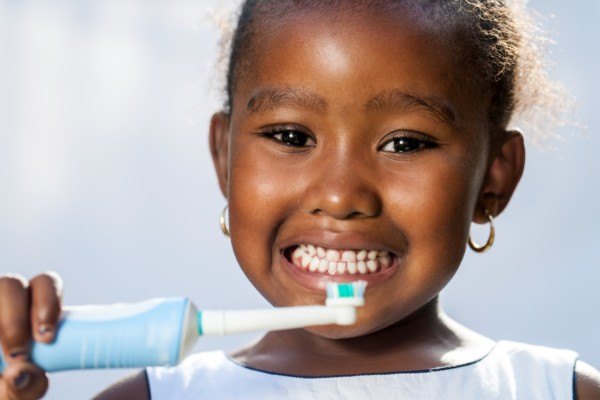 A young patient holding a toothbrush